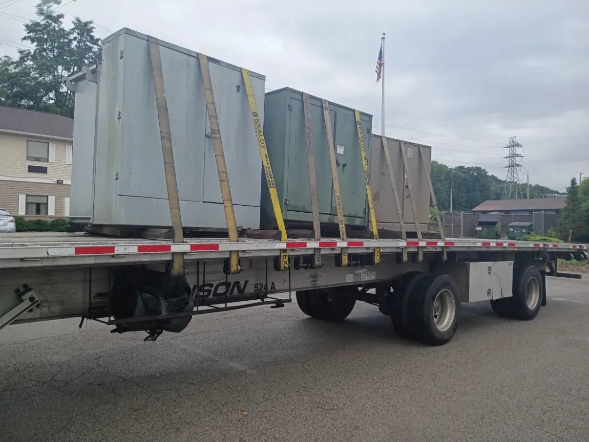 Wrapped and braced switchgear sections on a flatbed — Oxnard, CA