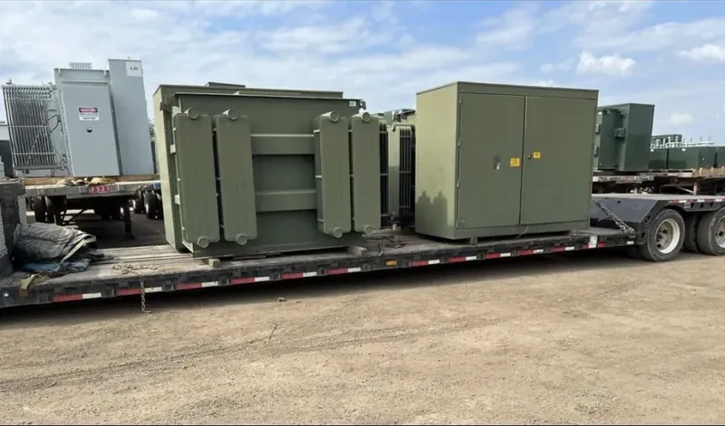 Transformers and enclosures strapped to a flatbed trailer — Modesto, CA
