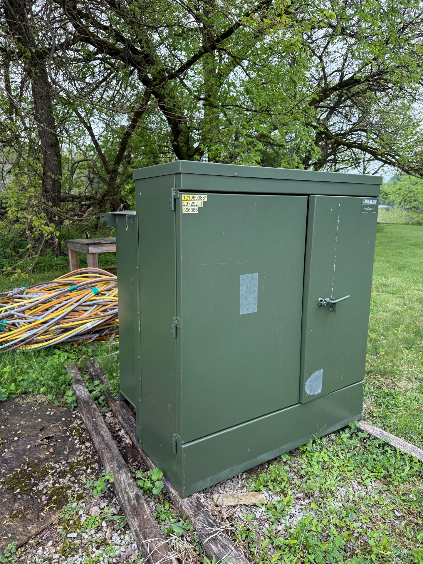 Green pad-mount transformer set on a concrete pad — Gilbert, AZ