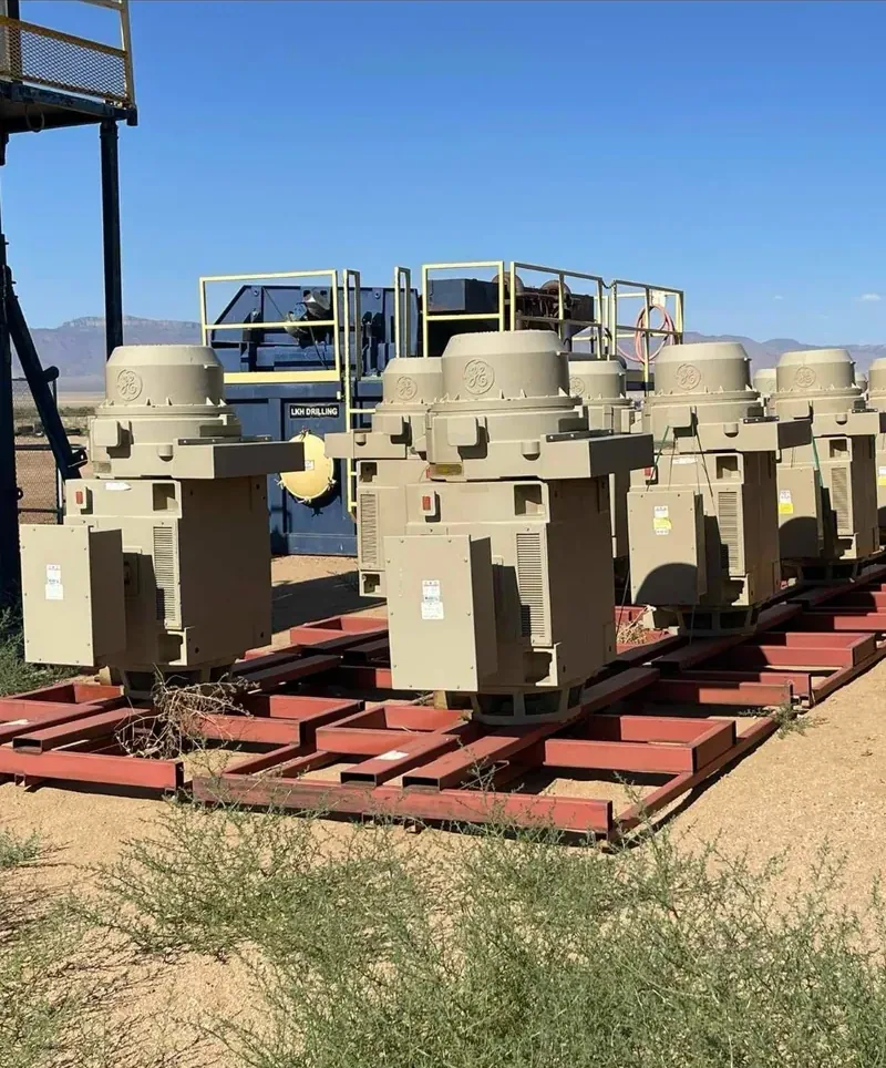 Row of distribution transformers on steel racks in a yard — Irvine, CA
